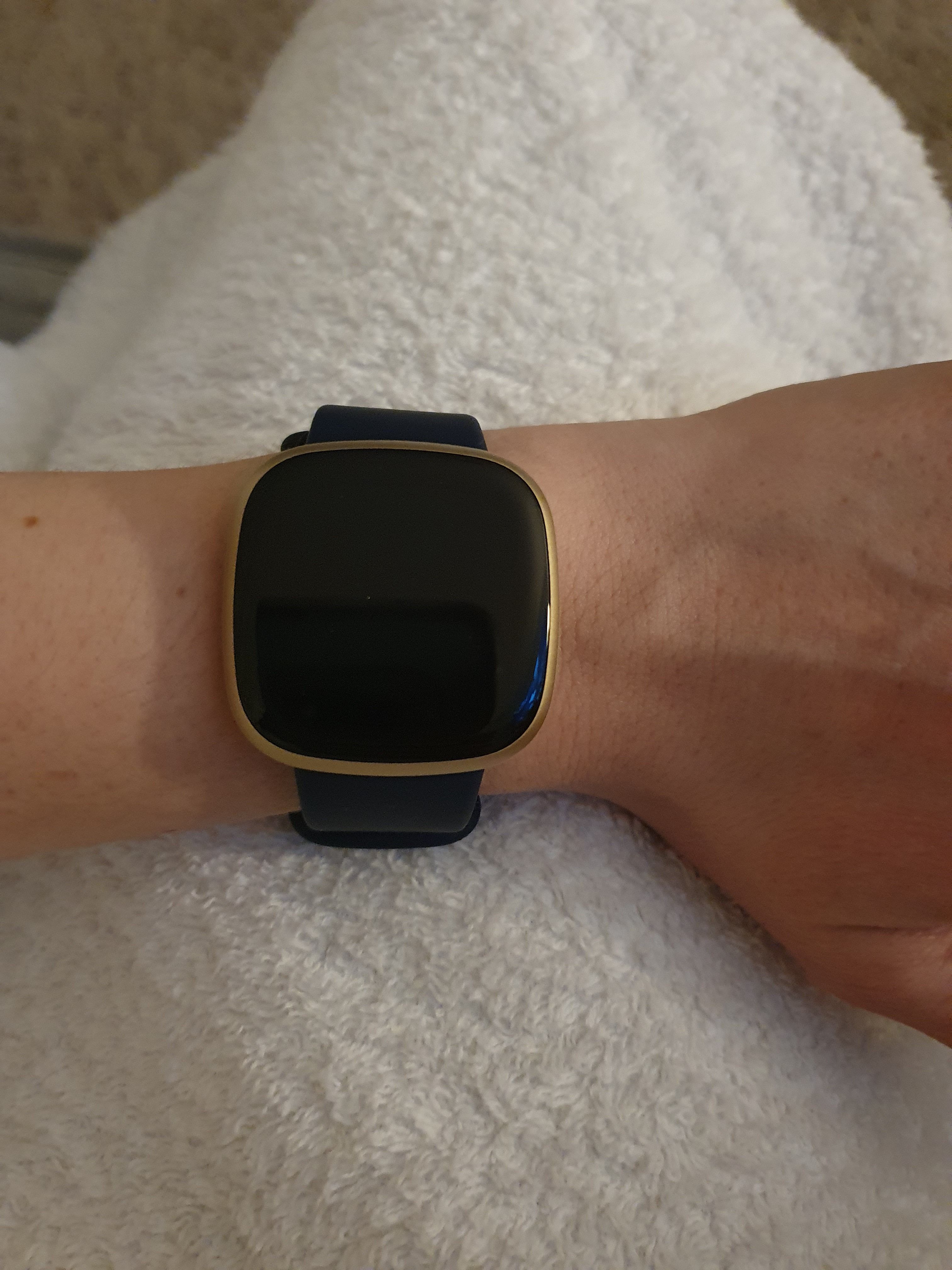 Fitbit versa on store woman's wrist