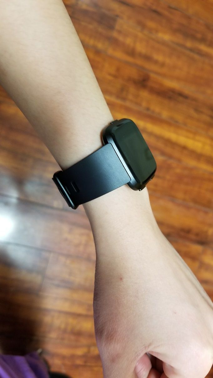 Fitbit versa store on woman's wrist