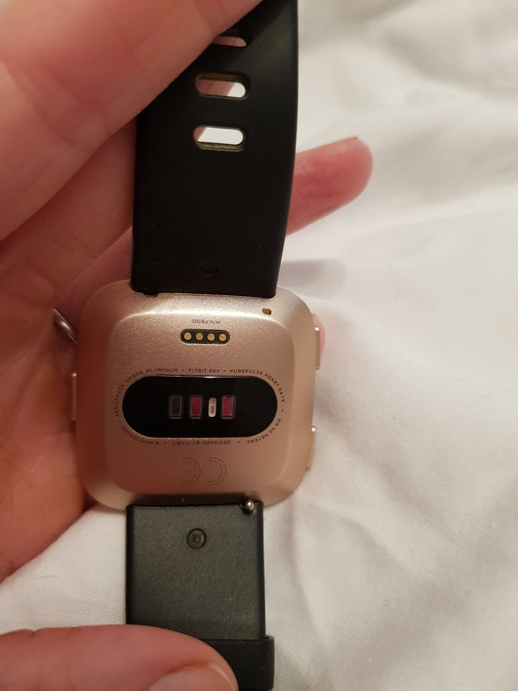 how to change strap on fitbit versa