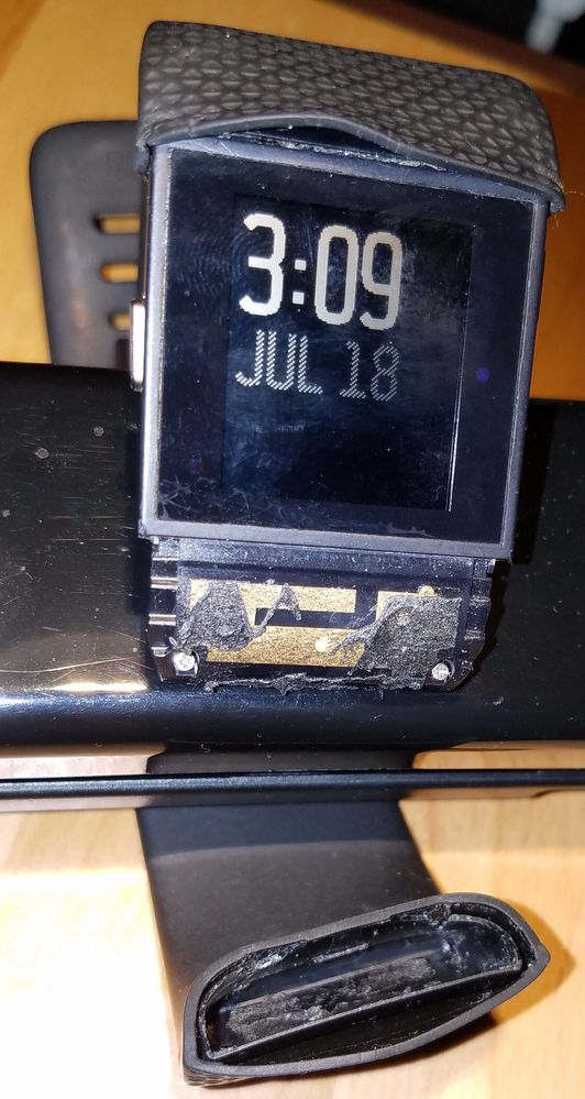 Fitbit Surge with disintegrated watch band.