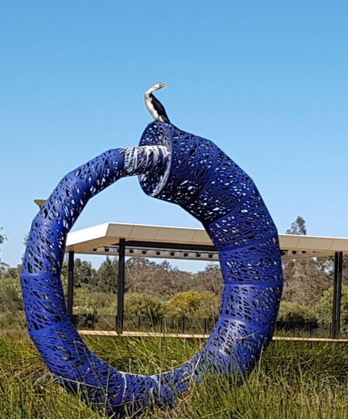 Bird on top of a sculpture