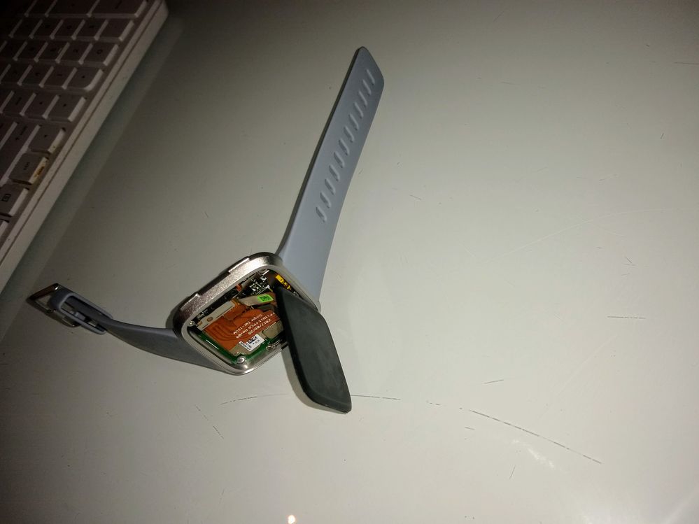 Faceplate separated from the body of Fitbit Versa watch.
