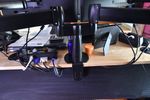 Monitor stand clamped to desk.