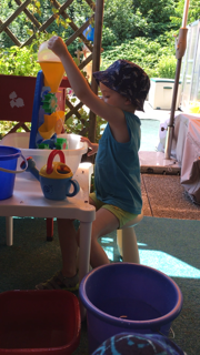 Flynn playing with a funny water wheel